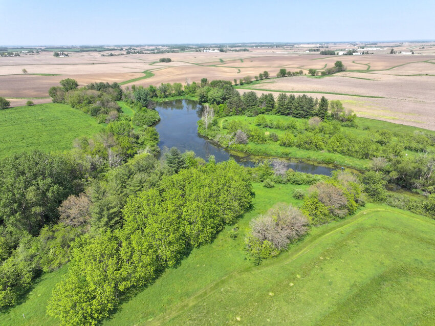 An aerial view of the Kuehl's prairie, and pond amid corn and bean fields. The property was deeded to the Iowa Natural Heritage Foundation.