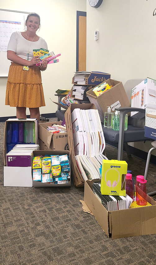 United Way of Muscatine&rsquo;s school supply drive netted 15 boxes of items, brought to the schools Monday. Second grade teacher Grace Finnegan gets a first hand look! Photo contributed.