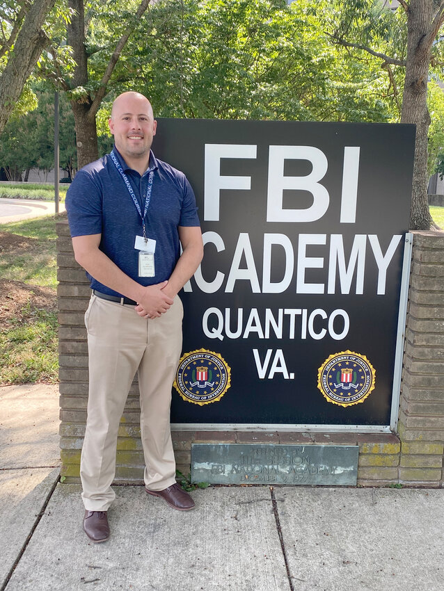 Eldridge Police Chief Andrew Lellig poses at the academy where he received leadership training.