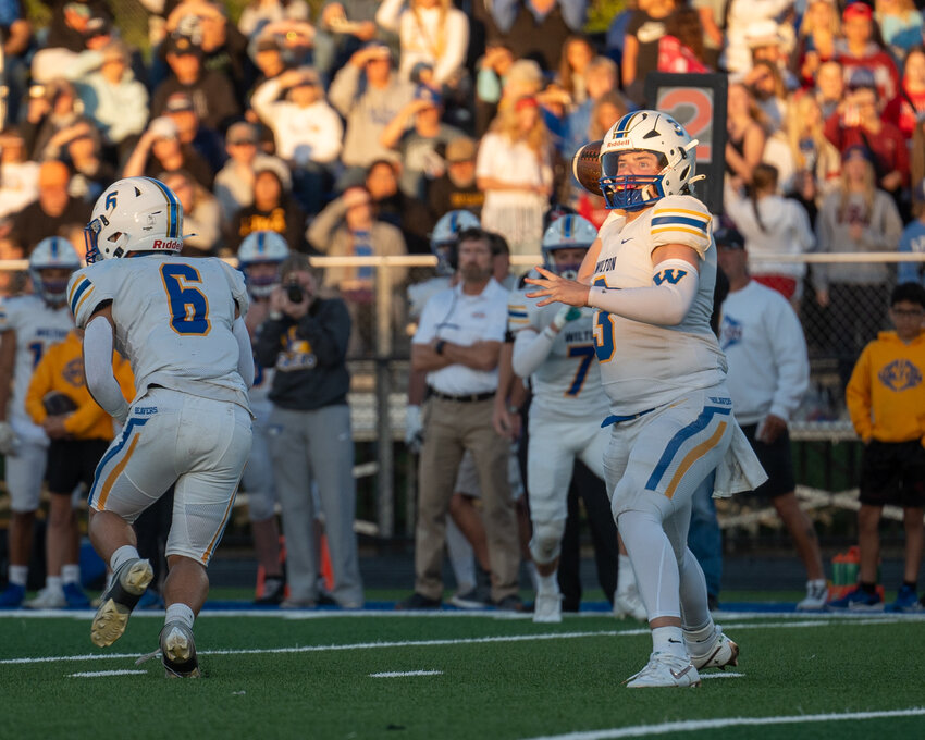 Wilton's Drew Keith readies to throw a screen pass.Advocate File Photo by Kohlton Kober