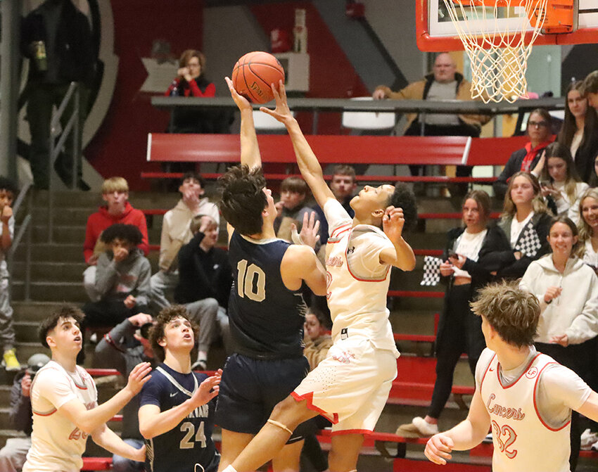 5-foot-11 Lancer freshman Vasaun Wilmington gets all ball on 6-foot-2 Spartan junior Gavin Kettmann.