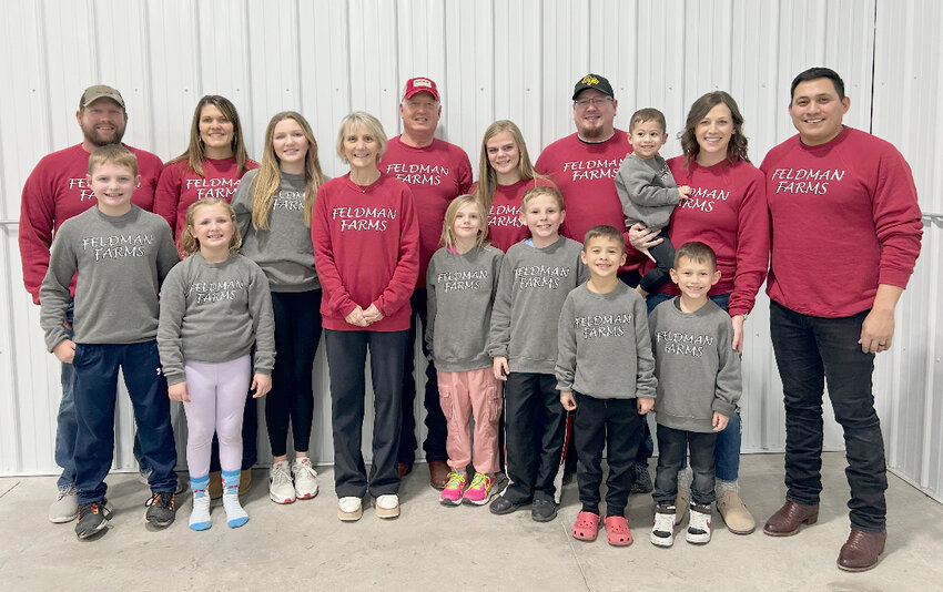 Left to right in the red shirts are Nick Feldman, Becky Feldman, Tammy Feldman, Adam Feldman, Ashley Feldman, Jason Feldman, Abby Ortiz, and Edgar Ortiz. Left to right in the grey shirts are Zach Feldman, Makenzie Feldman, Kaelyn Feldman, Hadley Feldman, Kolby Feldman, Wyatt Ortiz, Hudson Ortiz (being held by Abby Ortiz), Emmitt Ortiz.                                                                 Contributed photo
