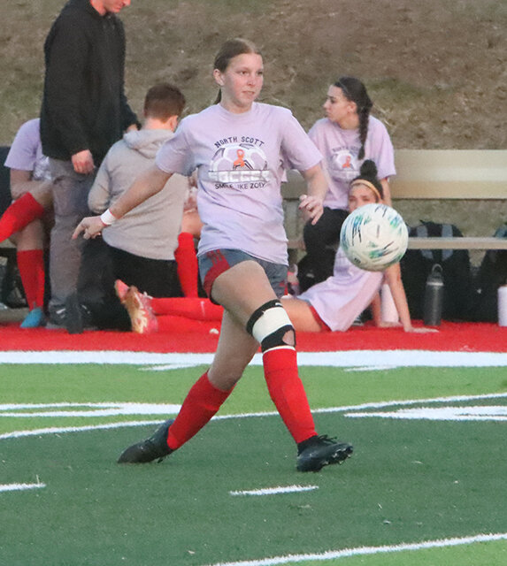 Senior Kaili Johnson boots the ball upfield as North Scott and Davenport Central tried to break a scoreless scrimmage late in the second half.