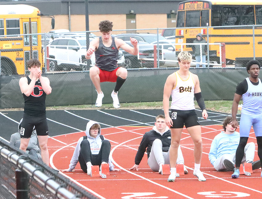 Junior Sam Dickman stays loose ahead of the 100-meter dash