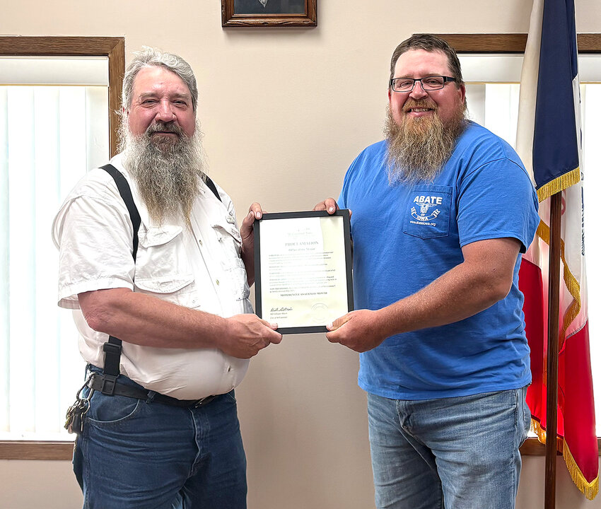 McCausland mayor Bill Gillespie presents a mayoral proclamation to Ben Miller of ABATE of Iowa naming May &quot;Motorcycle Awareness Month.&quot;