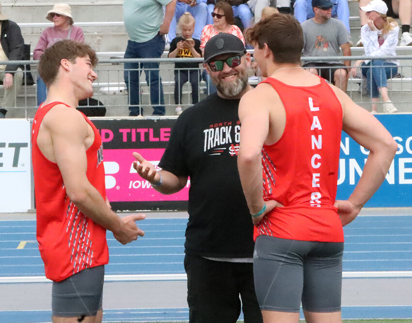 Lancer coach Tom Peppers shares a laugh with his throwers, Joey Honeywell and Trey Feist, after Friday afternoon's event.