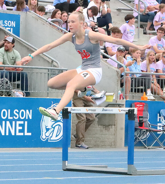 Sophi Schneckloth soars over the low hurdles blocking her path in her 400-meter run.