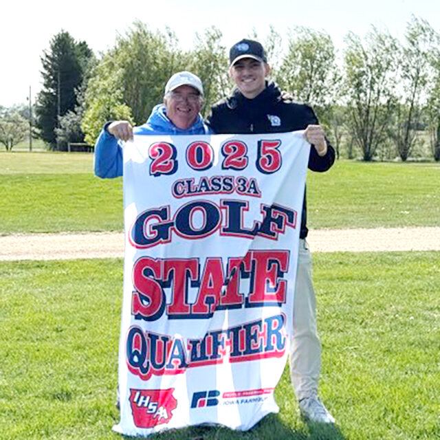 Dave Shield (left) and Nick Frenz (right) hold the state qualifier banner.
