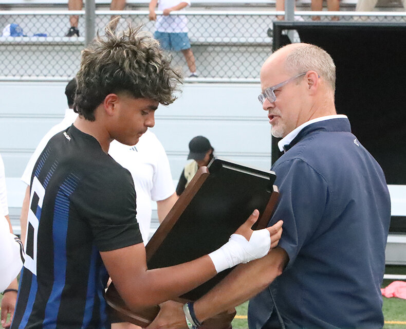Javier Andrade-Martinez accepts West Liberty's state quarterfinalist plaque.
