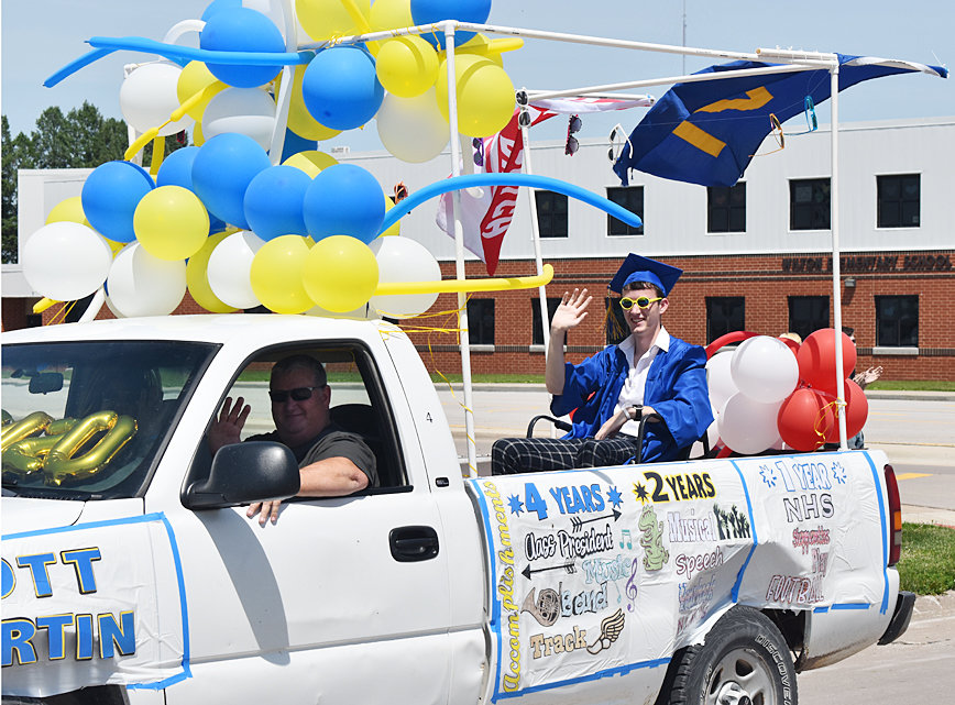 Wilton senior class president Scott Martin is shown riding in the back of a truck driven by his father during a grad parade held for the Wilton class of 2020 May 31.