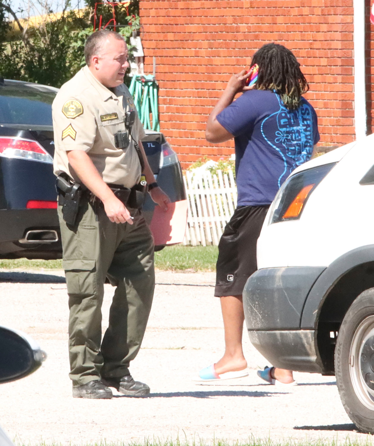 Deputies question a woman who  walked from the building.