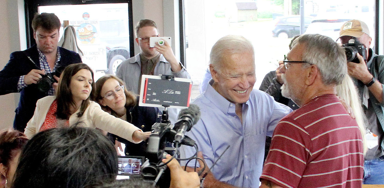 Press corps follows Biden into Tasty Cafe.