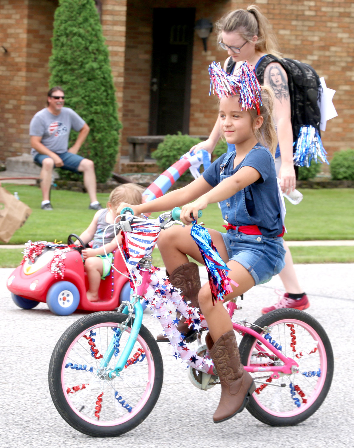 Hailey Carter bikes down Princeton's streets with the parade.