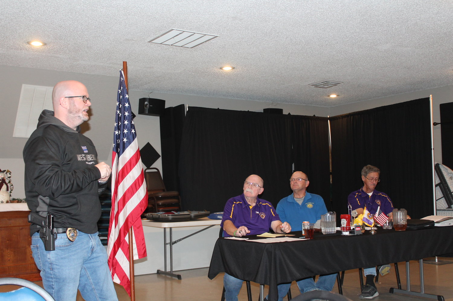 West Liberty Police Chief Eric Werling addresses the West Liberty Lions Club about the Shop with the Cop program.