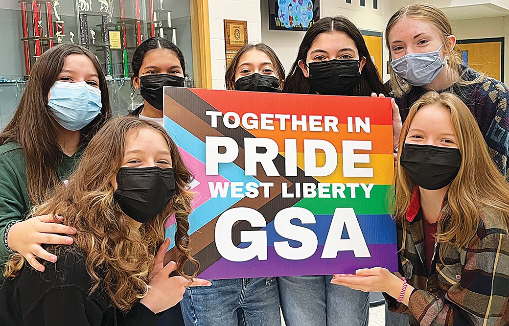 Members of the West Liberty High School Gay Straight Alliance group pose with their new sign they are promoting in the community as a fundraiser.