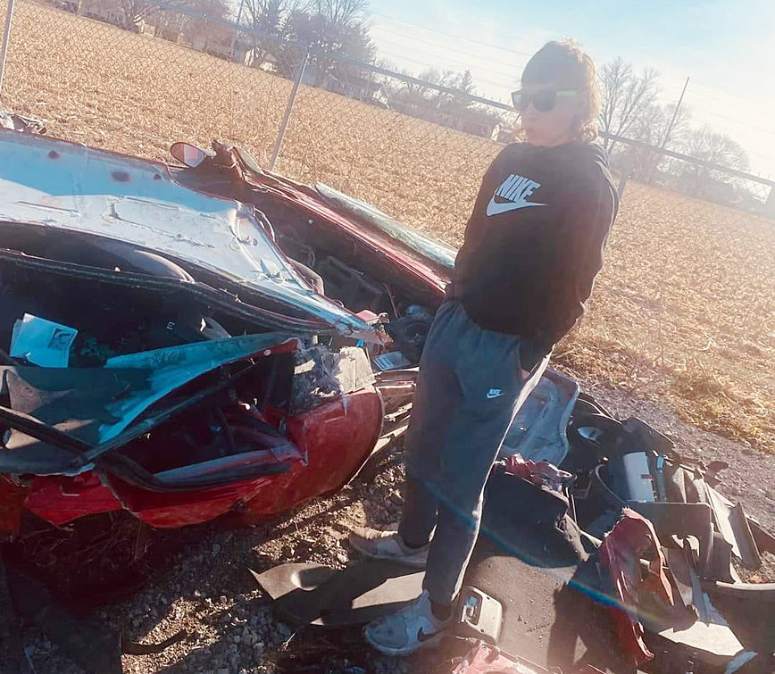 Jakob Niles, the passenger in the car with Daryn Clark at the time of the accident, walked away with minor injuries. He is shown above observing the wreckage days later.