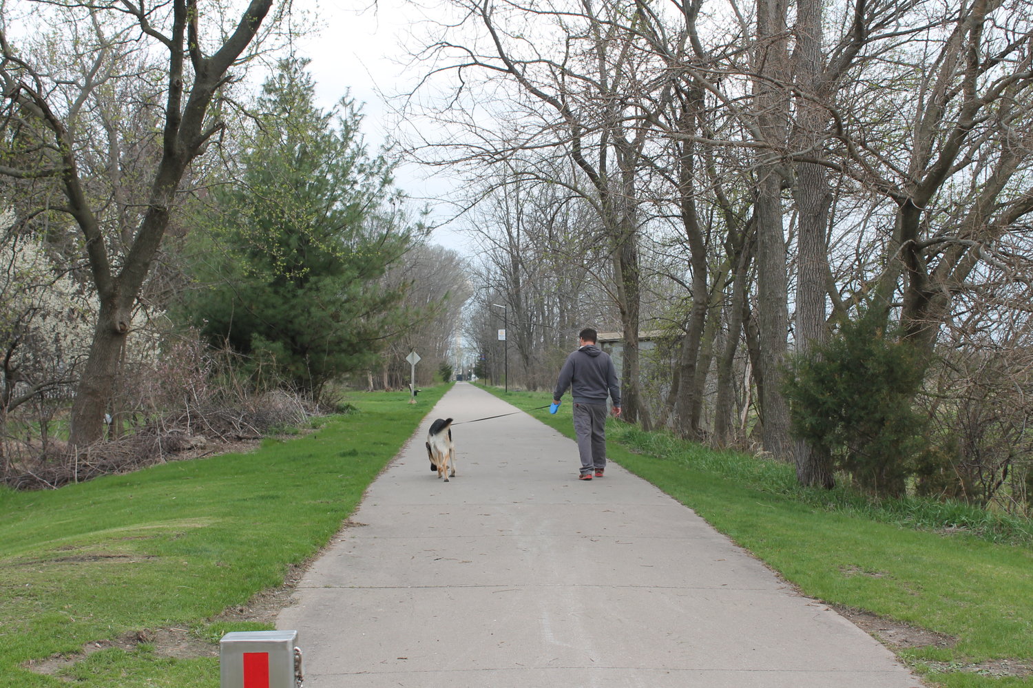 Dreams of more trails in West Liberty came up at the WeLead "Destination Iowa" grant proposal meeting, something Buddy and his owner, Dane Lovell, might find appealing, caught here taking a walk Monday evening on the Hoover walking/bike trail.
