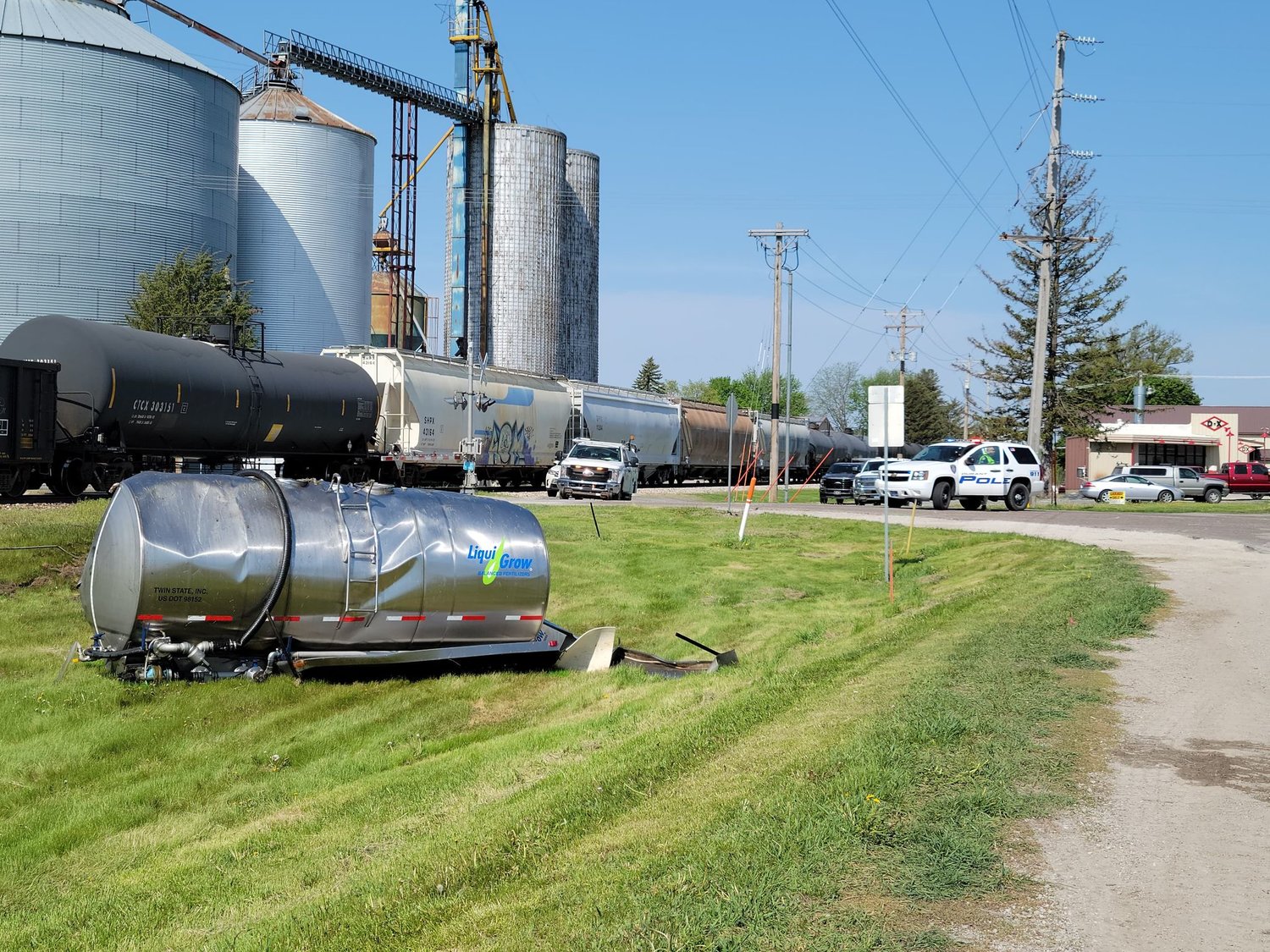 An eastbound train collision with a Liqui-Grow truck left this tank next to tracks in Durant Friday morning.