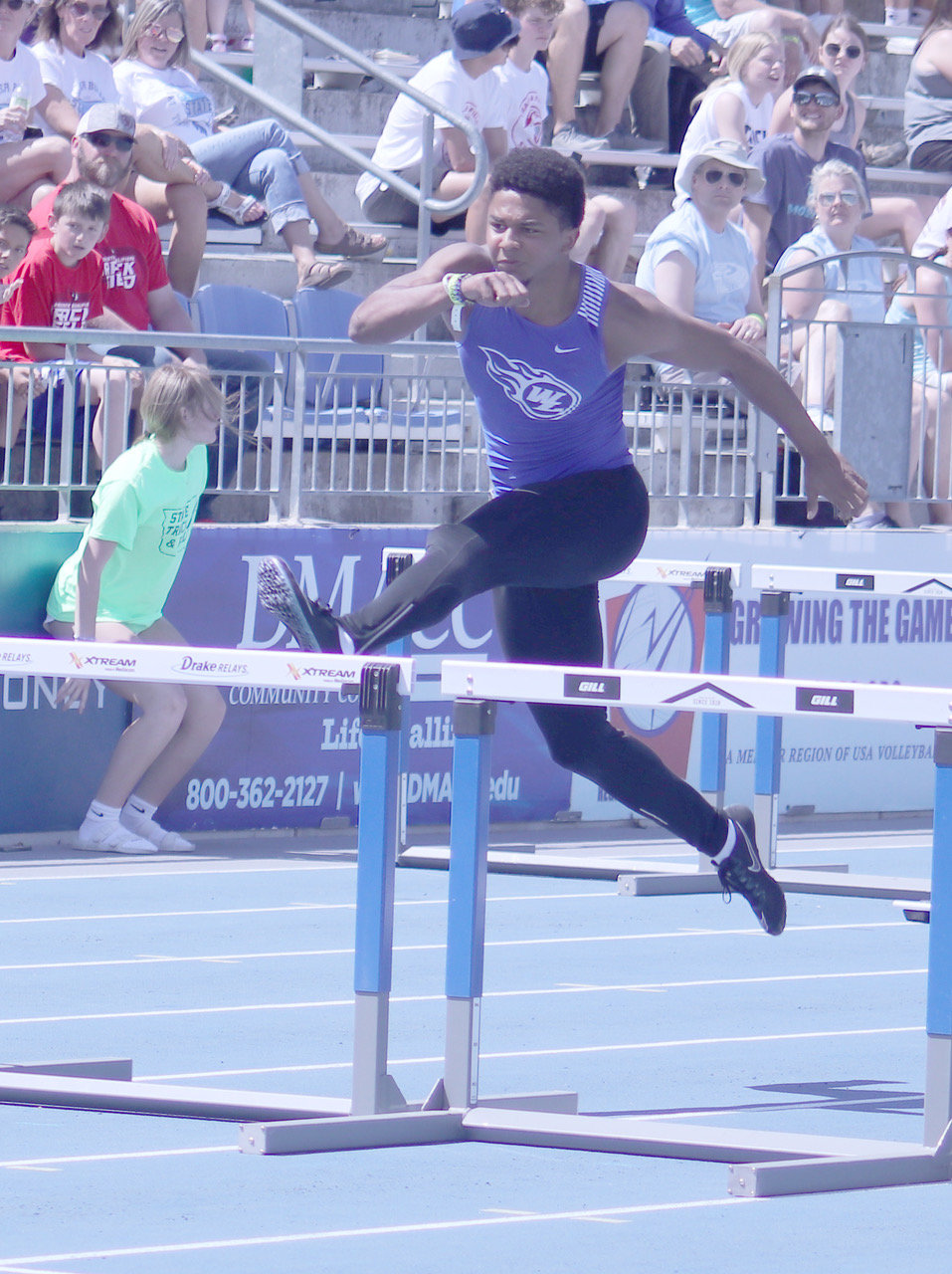 WL senior Jahsiah Galvan lifts himself over the hurdle during last week's state track meet in Des Moines in the boys shuttle hurdle relay.
