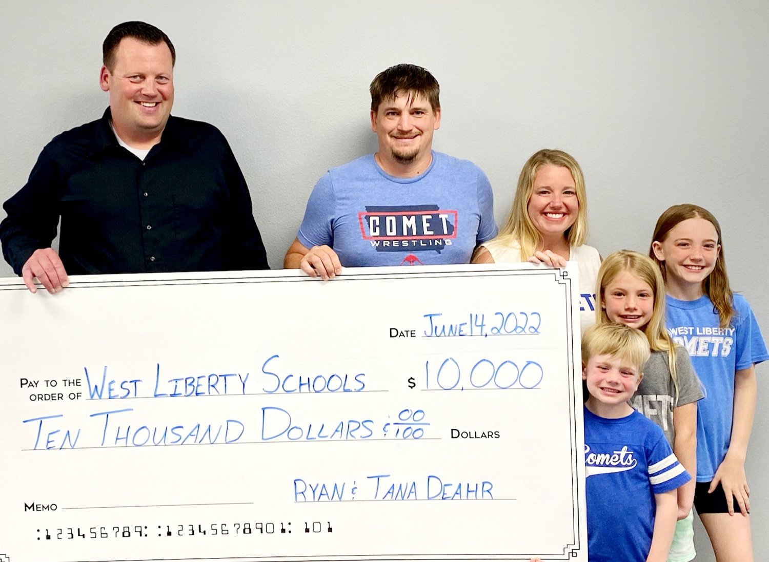 Activities director Adam Loria with members of the Deahr family who donated $10,00 to the athletic complex project.