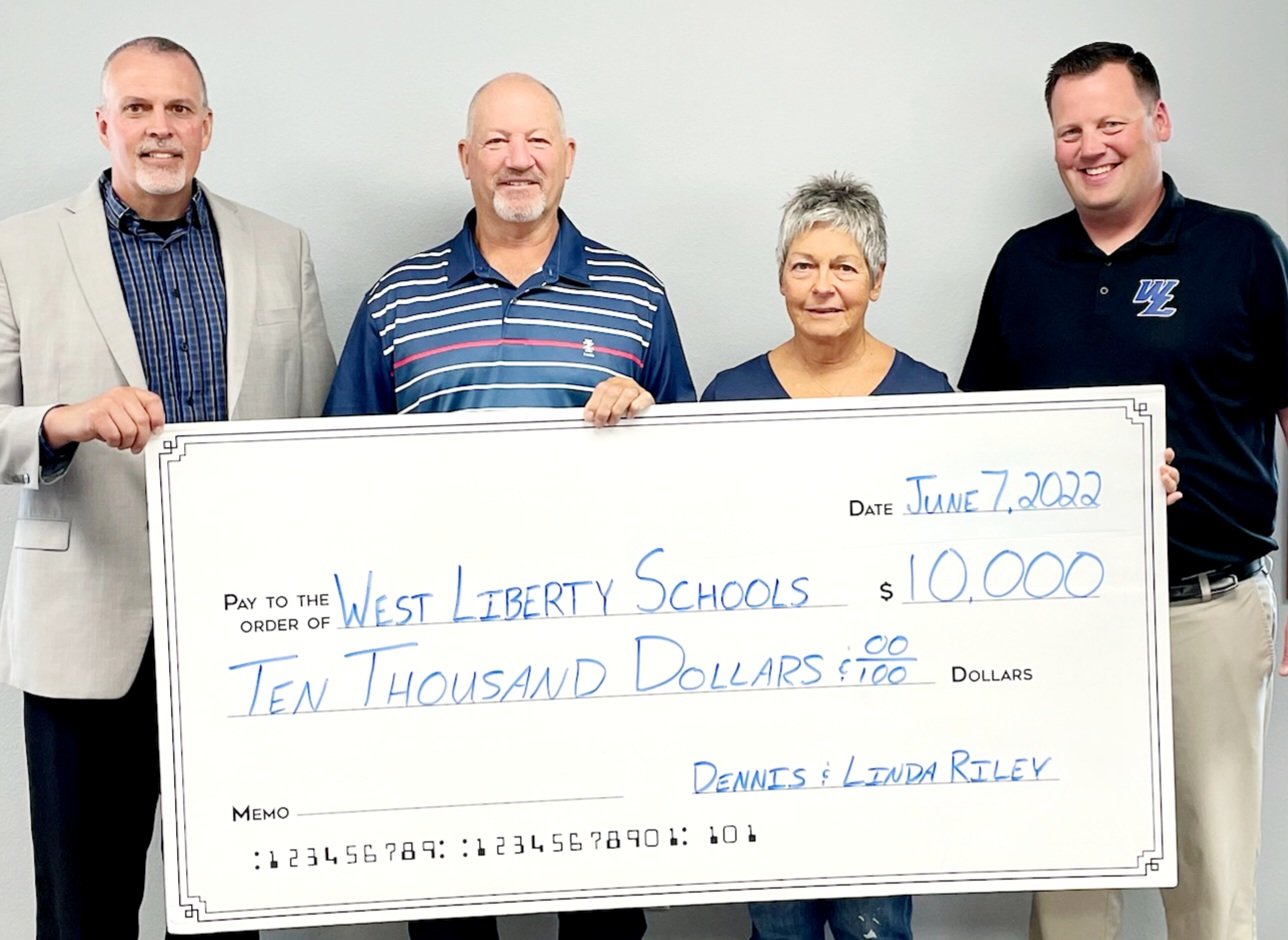 From left, West Liberty School Superintedent Shaun Kruger, Dennis Riley and Linda Riley, athletic director Adam Loria with the $10,000 the Riley's donated to the proposed WLHS athletic complex . Dennis taught math and physical education and coached several sports while his wife volunteered at the Early Learning Center and was the accompianist for the middle school choir.
They met with Kruger and Loria to let them know they were going to donate to the athletic complex earlier this week.