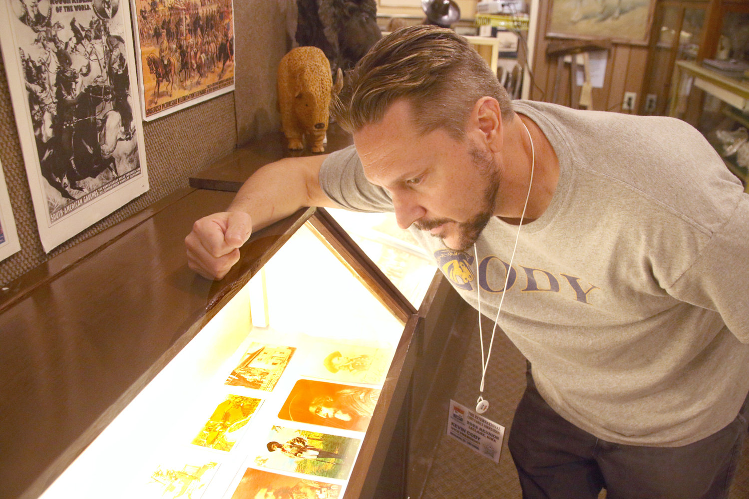 Kevin Cody, originally from Cody, Wyo., examines artifacts at the Buffalo Bill Museum in LeClaire.  The Cody family has over 3,000 pieces of Buffalo Bill memorabilia in their own collection and acquired some more in Iowa.