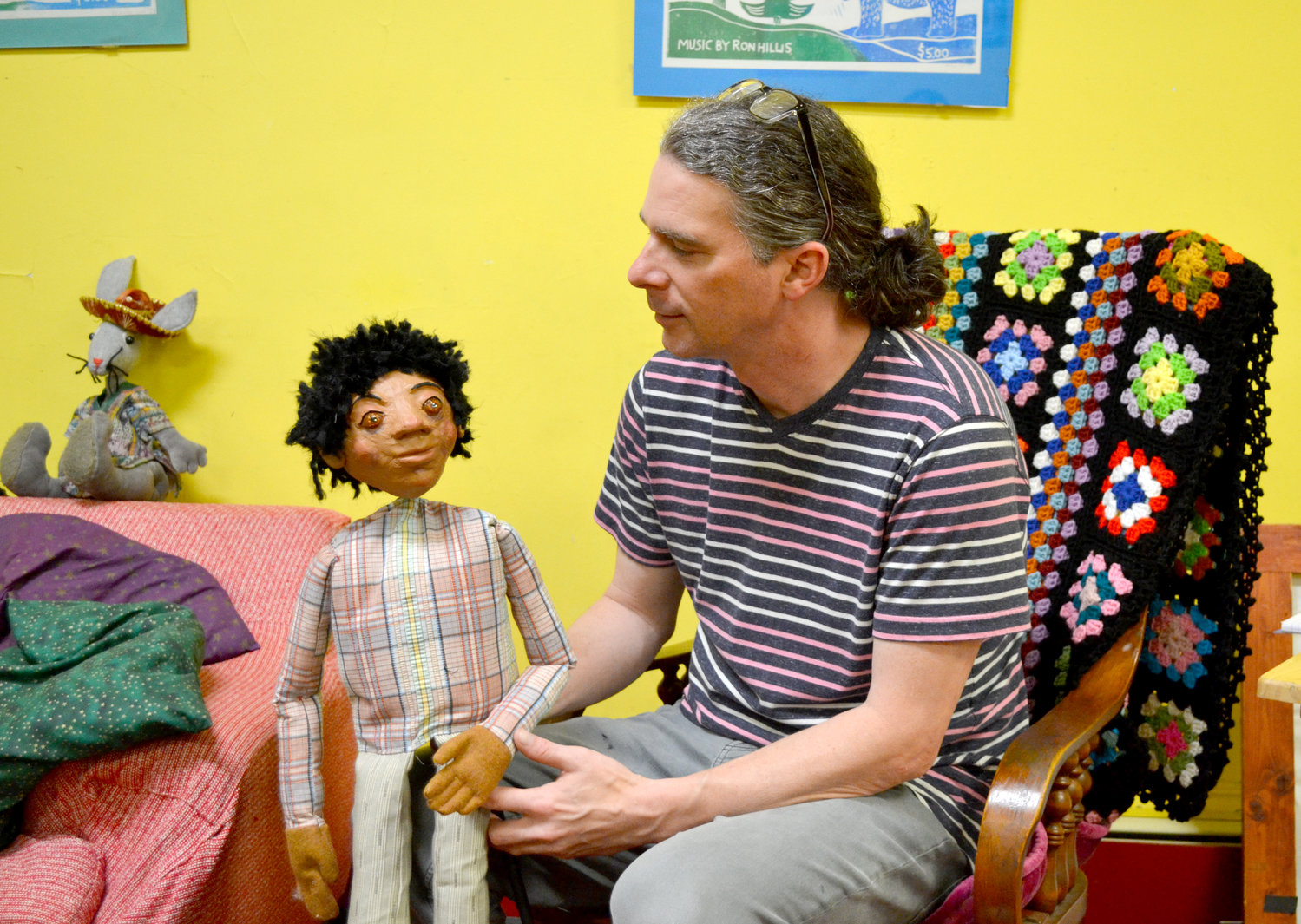 Christopher Eck holds one of the rod puppets from the performance, “Remembering Buxton.”