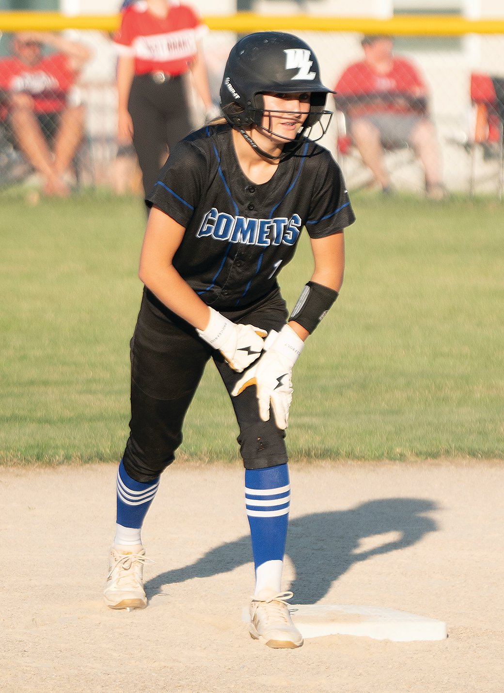 Kiley Collins stands on second base waiting for her teammate to hit the ball.