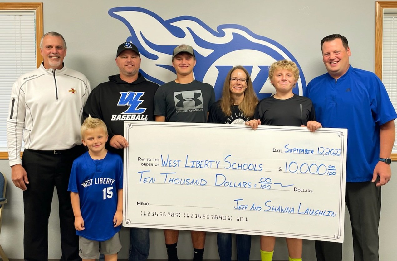 Pictured from left are West Liberty Community School District Superintendent Shaun Kruger, the Laughlin Family and West Liberty School District Athletic Director Adam Loria.