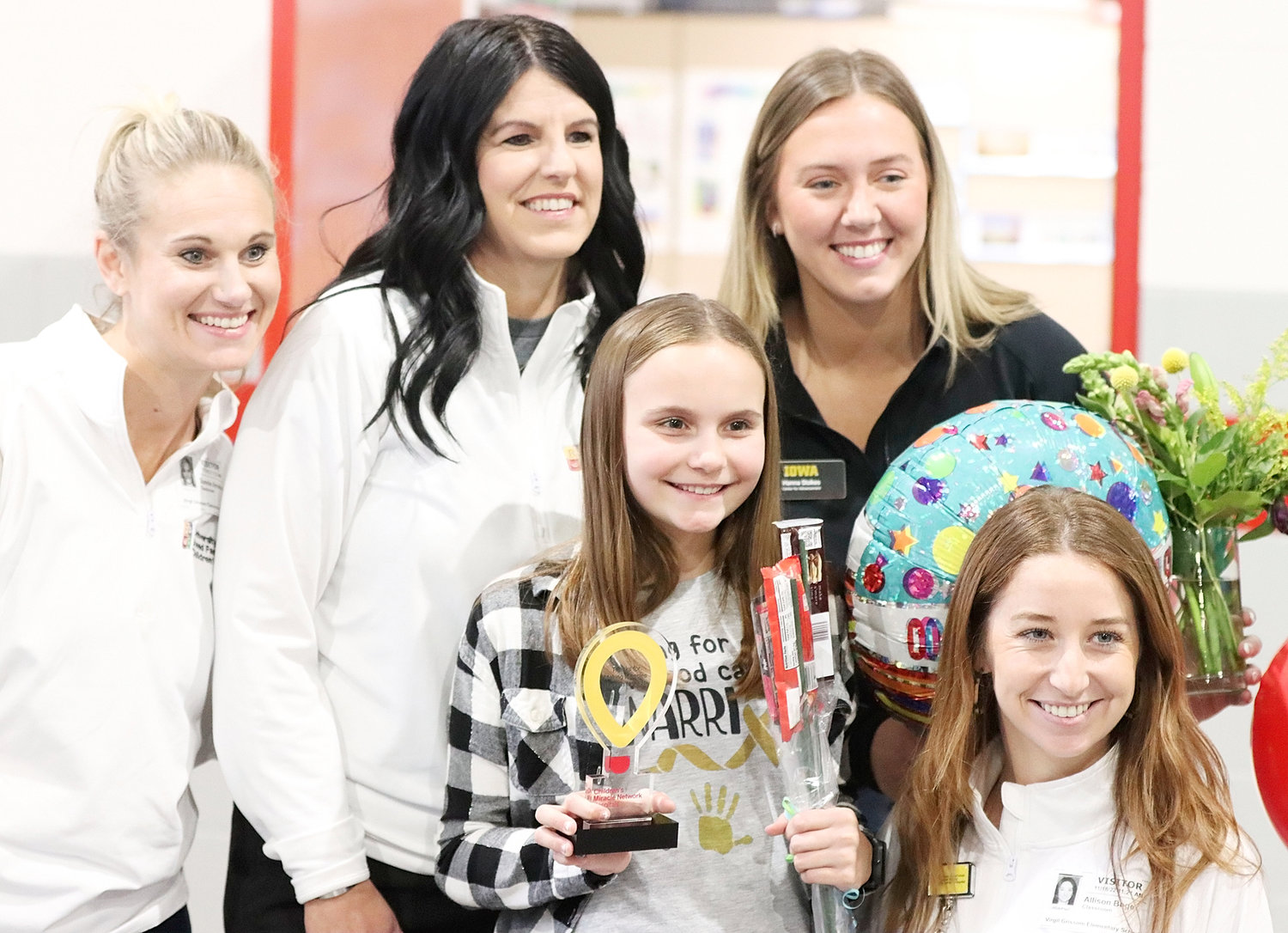 There were plenty of smiles in the Virgil Grissom lunch room on Friday when members of the University of Iowa's Stead Family Children's Hospital fundraising team were on hand to name fifth-grader Kinley Albrecht as their champion for 2023. Surrounding Kinley were (l-r): Sunnie Amelon, Andrea Chambers, Hanna Stokes, and 2016 North Scott graduate Allie (Stutting) Boge.