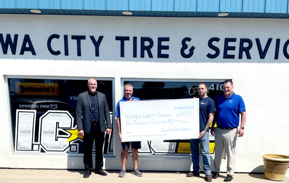 Pictured from left is West Liberty Community School District Superintendent Shaun Kruger, business owners from Iowa City Tire and WLCSD Athletic Director Adam Loria with the $10,000 donation.