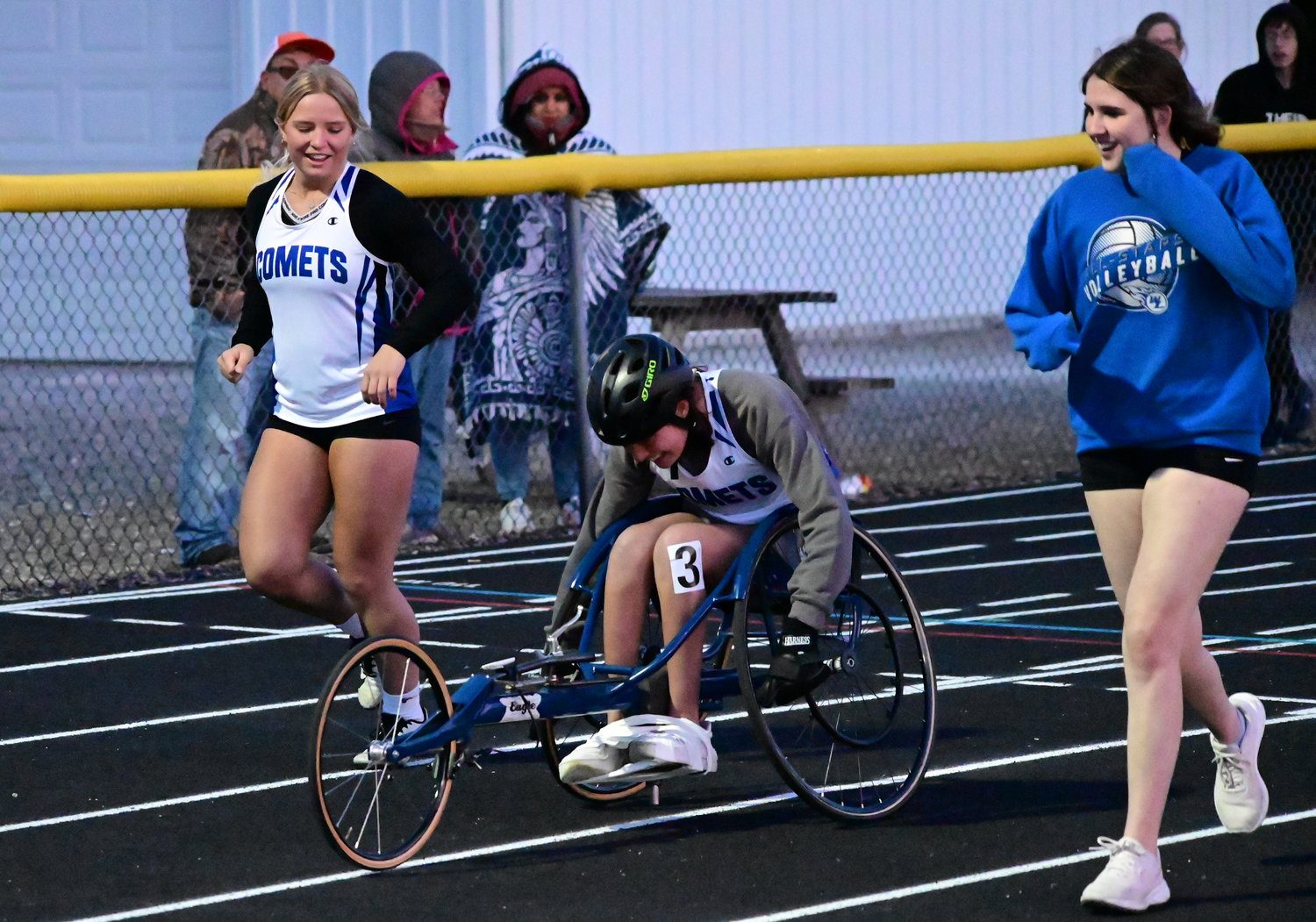 From left are Pearson Hall, Payton Maas and Alyssa Lenz at the Wapello Track Meet last Tuesday. Hall and Lenz ran the race with Maas during the wheelchair event for the 200-meters.
