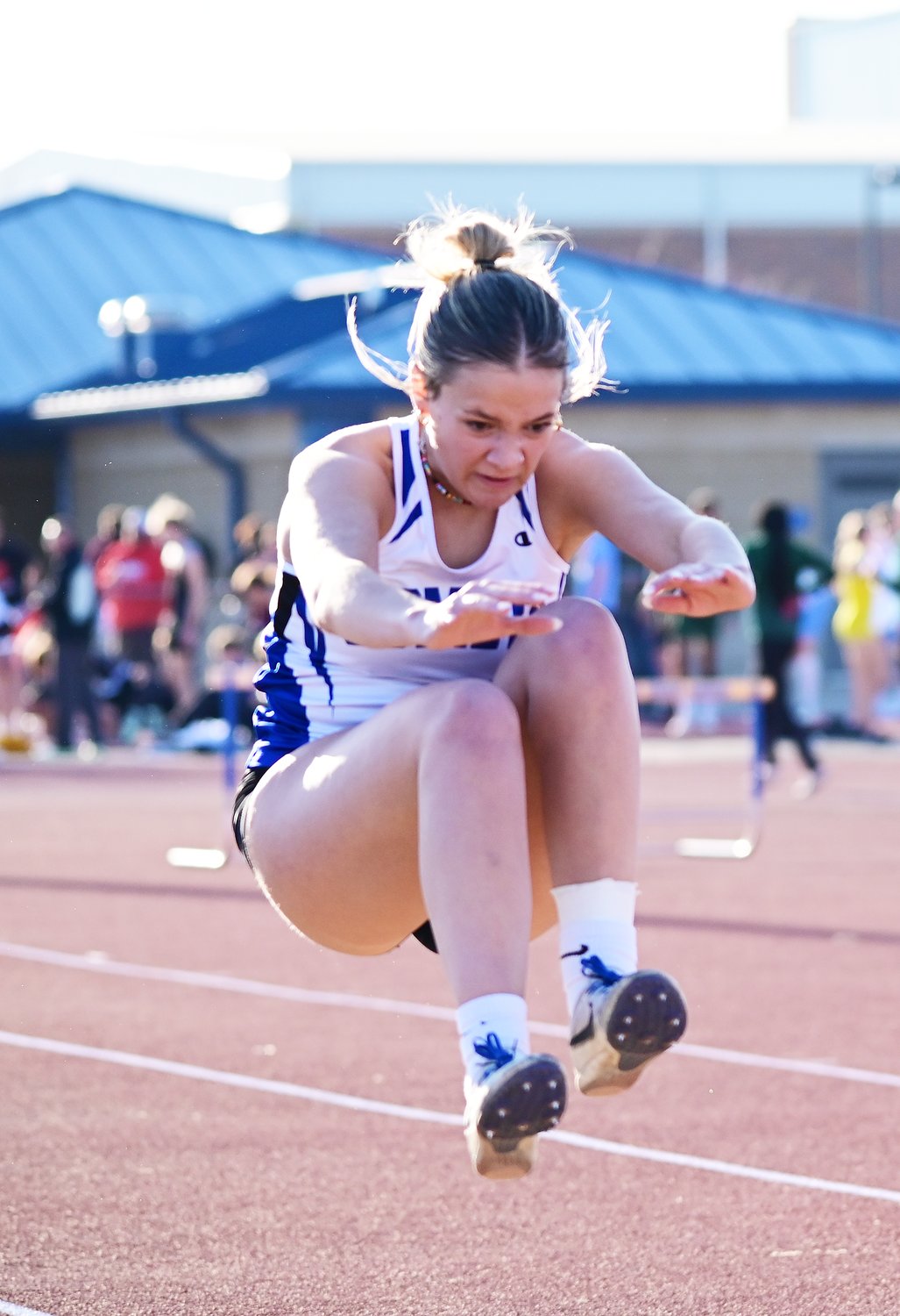 Laney Esmoil participates in the long jump during the Clear Creek Amana track meet.