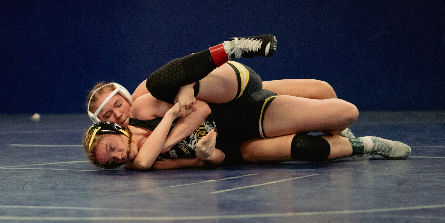 Senior Nellie Stagg works for a cradle against her opponent in the first round of Monday's home wrestling meet.