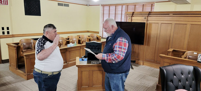 Rick Dunn being sworn in by County Judge Chris Porter as Veterans Service Officer.