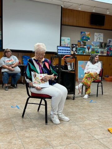 Ann Franklin, immediate past President of Altrusa of Pampa, reads to kids at the Summer Reading Program at the Lovett Memorial Library