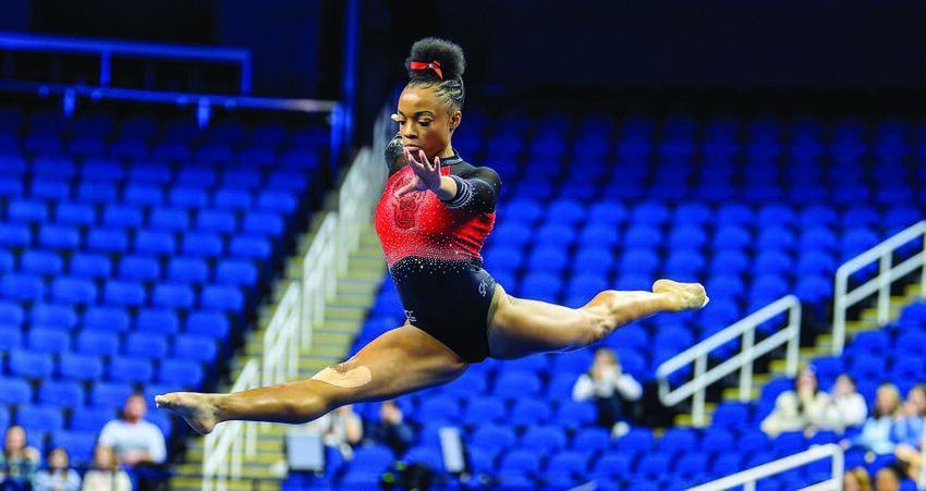 N.C. State sophomore Ashley Knight (Southern Guilford Alumna) leaps during her floor exercise performance at the ACC Championships held at First Horizon Coliseum in Greensboro.