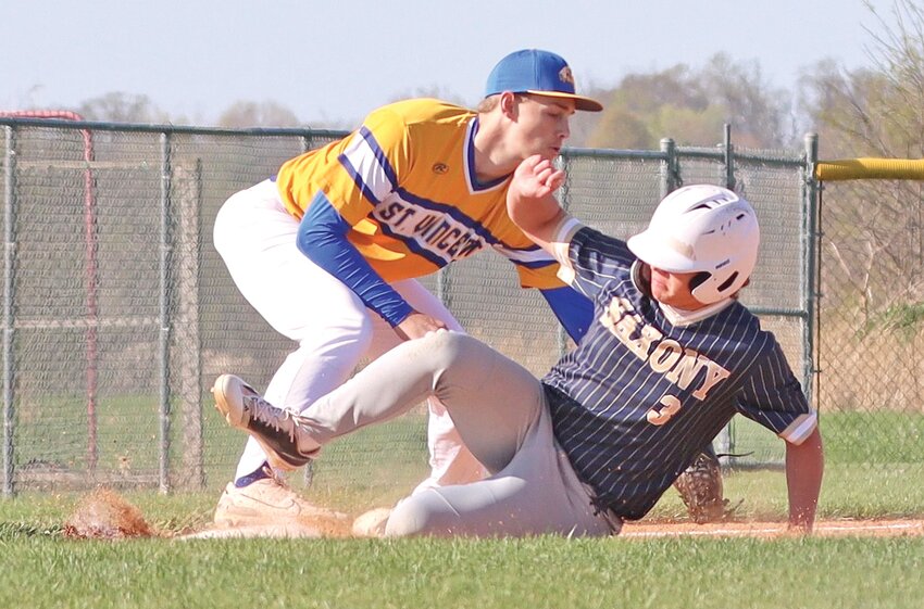 St. Vincent third baseman Conner Roth tries to tag Saxony Lutheran shortsop Jason Sparks during the second inning of the Crusaders' 15-2 victory over the visiting Indians. The Crusaders had 16 hits in the game