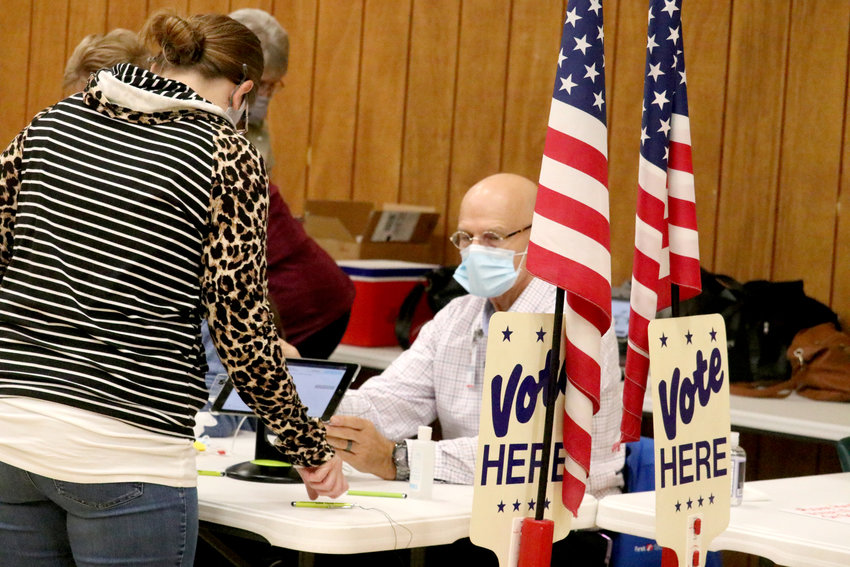 Greg Schimpf helps a voter sign in Tuesday morning at the Perry Park Center polling station. The Park Center location, which serves voters in the newly combined precincts of Perryville P-1 and P-4 saw 1,168 total voters. As a whole, Perry County saw a 72.65 percent voter turnout.