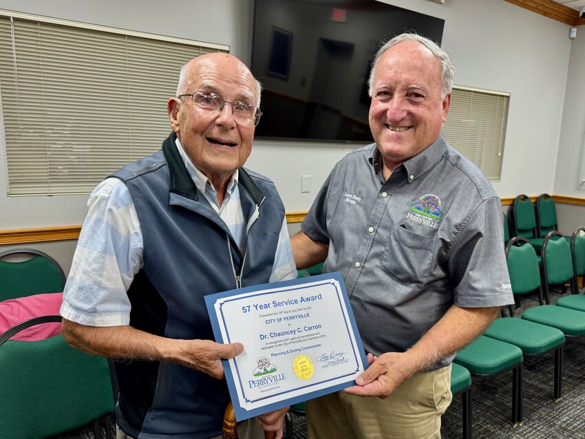 Perryville Mayor Larry Riney presents a certificate to 90-year-old Dr. Chauncey C. Carron recognizing him for serving 57 years on the city&rsquo;s Planning and Zoning Commission.
