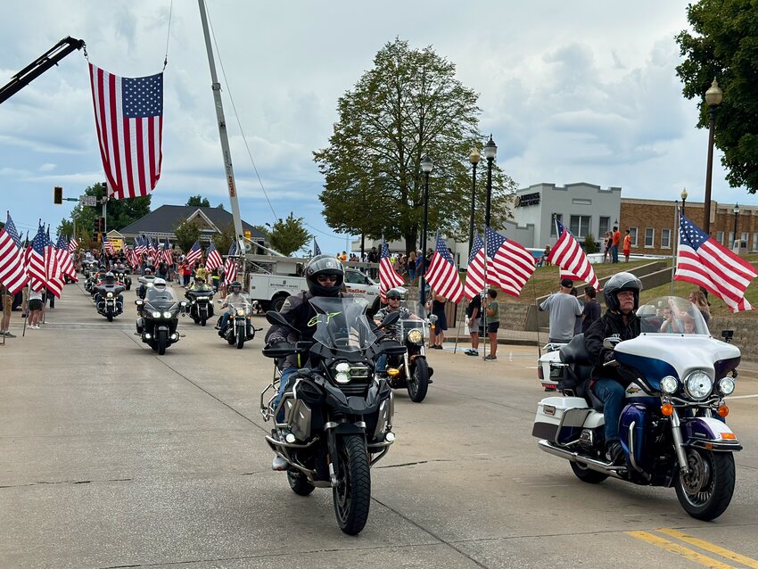 More than 200 motorcycles roar down West St. Joseph Street on Saturday afternoon as part of the 12th Annual Bikers on the Square in downtown Perryville. The riders came from across the country to participate in the emotional patriotic event.