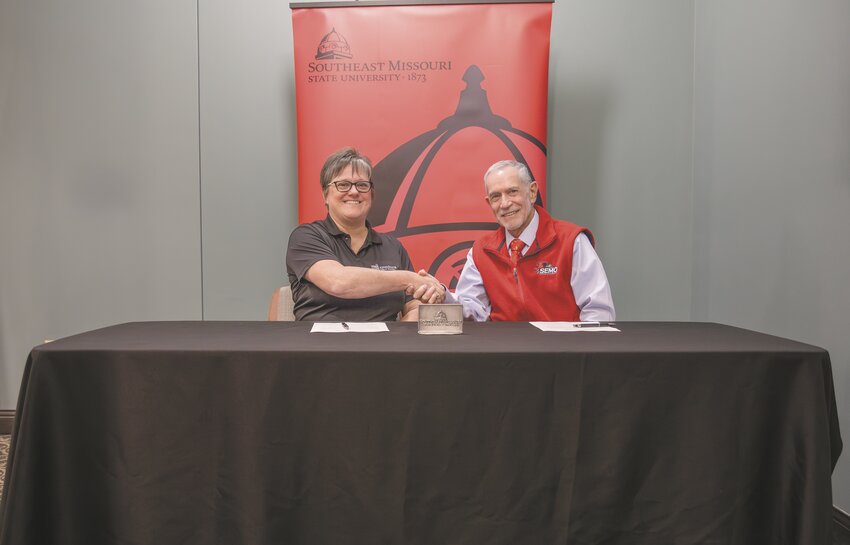 Altenburg Superintendent Debbie Haertling shakes hands with SEMO President Dr. Carlos Vargas after both sign an agreement allowing the school district to join the SEMO Educators Advantage program.