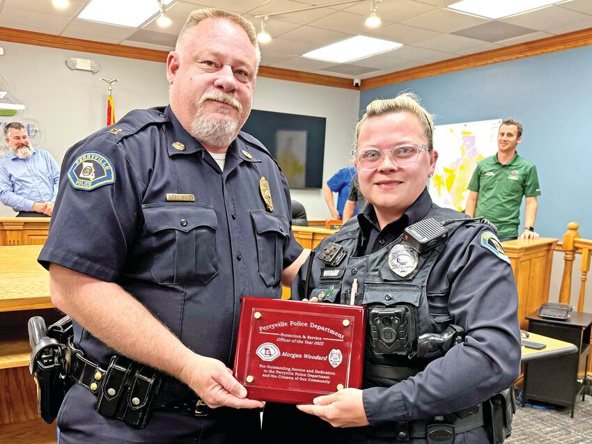 Capt. Ryan Worthington presents Officer Morgan Woodard with the Officer of the Year award during the Perryville Board of Aldermen meeting on April 1 in city hall.