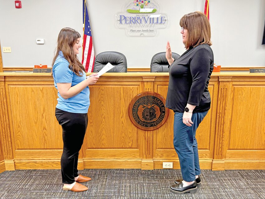 City Clerk Lydia Rellergert administers the oath of office to Kate Martin, who defeated incumbent Ward 2 Alderman Douglas Martin for the position with a vote of 147 to 120 in the April 8 election.