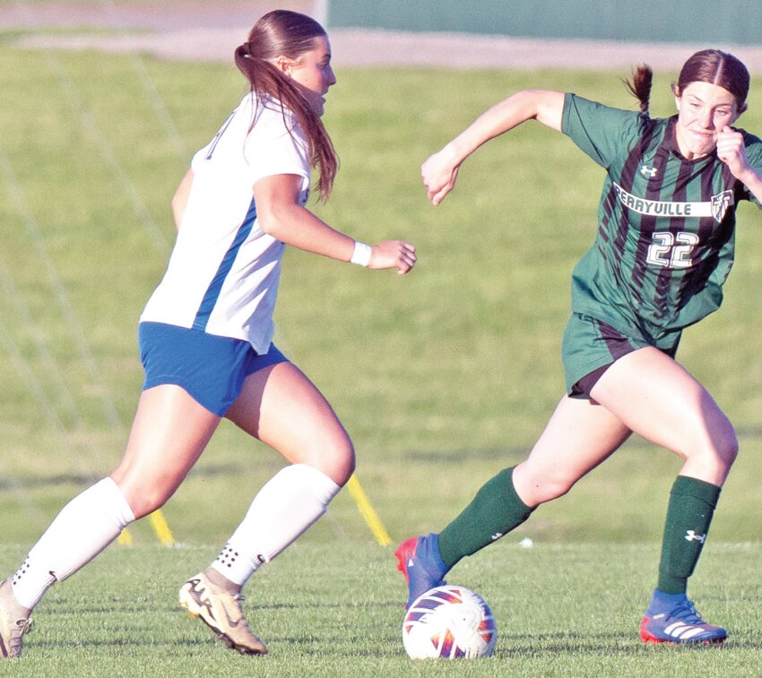 St. Vincent’s Lana Adams (left) moves the ball downfield under pressure from Perryville’s Caroline Gremaud during a match May 2 in Perryville. Adams, who finished the season with a conference-leading 53 goals and 10 assists, was named the Jefferson County Athletic Association’s Player of the Year.