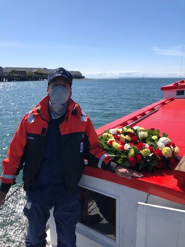 Gary Farrow, a U.S. Coast Guard Auxiliary Flotilla 19 member, aboard the Plover ferry during the blessing. Farrow said he took great pride in laying this year's wreath.