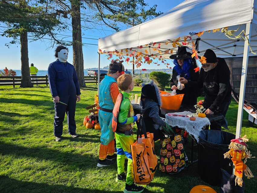 Children receive candy in front of the future Birch Bay Vogt Library Express during Trick-or-Treat on the Berm in 2023.