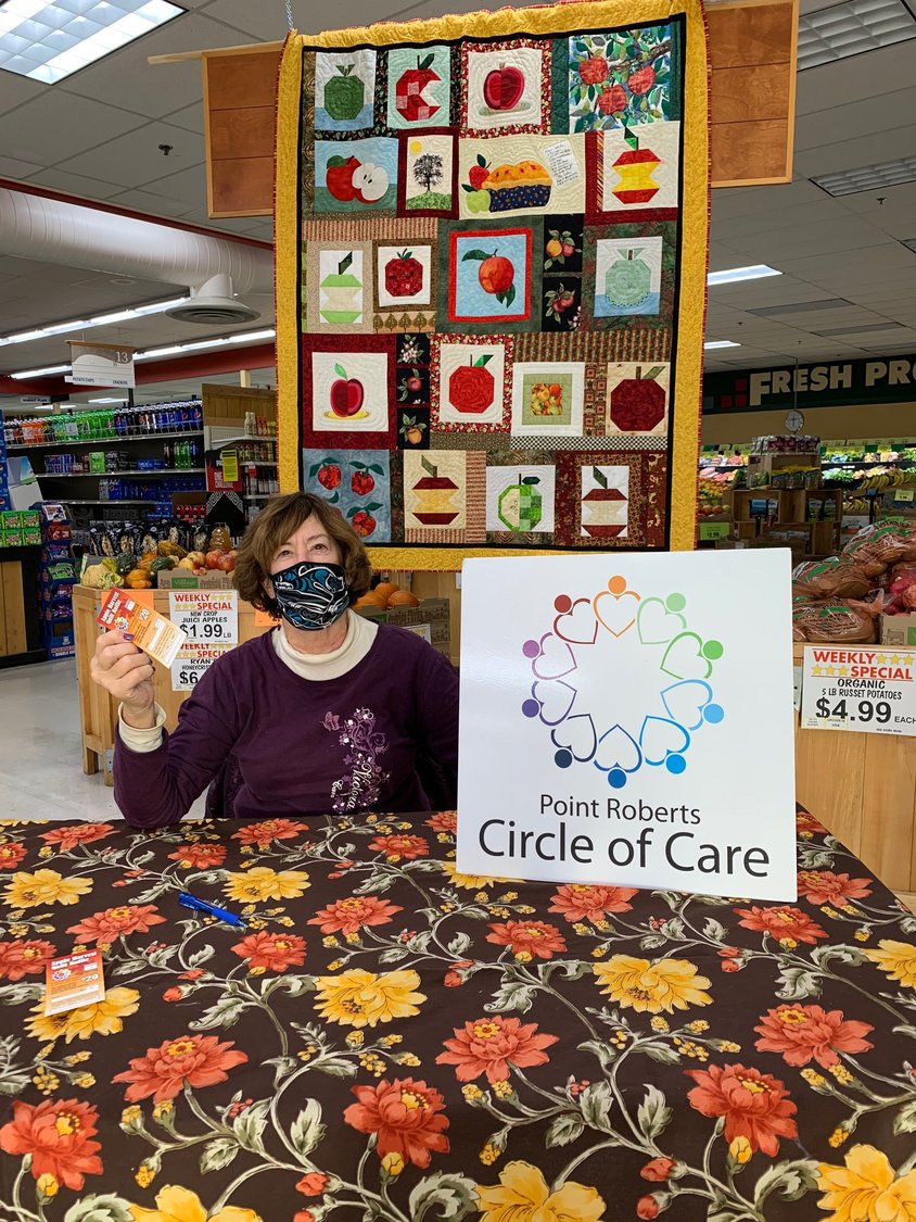 Barbara Bradstock selling raffle tickets at the Point Roberts Marketplace for the Apple Harvest Quilt, created by the Point Roberts Quilters, as a fundraiser for Point Roberts Circle of Care. Only 200 are being sold. The drawing will be held on December 19. For tickets, contact PRcircleofcare@gmail.com or 360/945-5222.