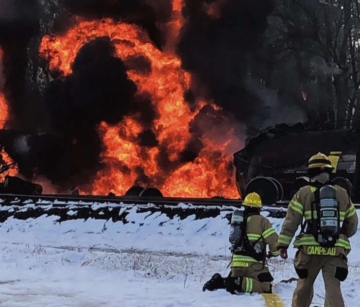 Kenneth Cunningham, a 2004 Blaine High School graduate and North Whatcom Fire and Rescue firefighter, and intern firefighter Donovan Campeau on the scene at the Custer train derailment on December 22.