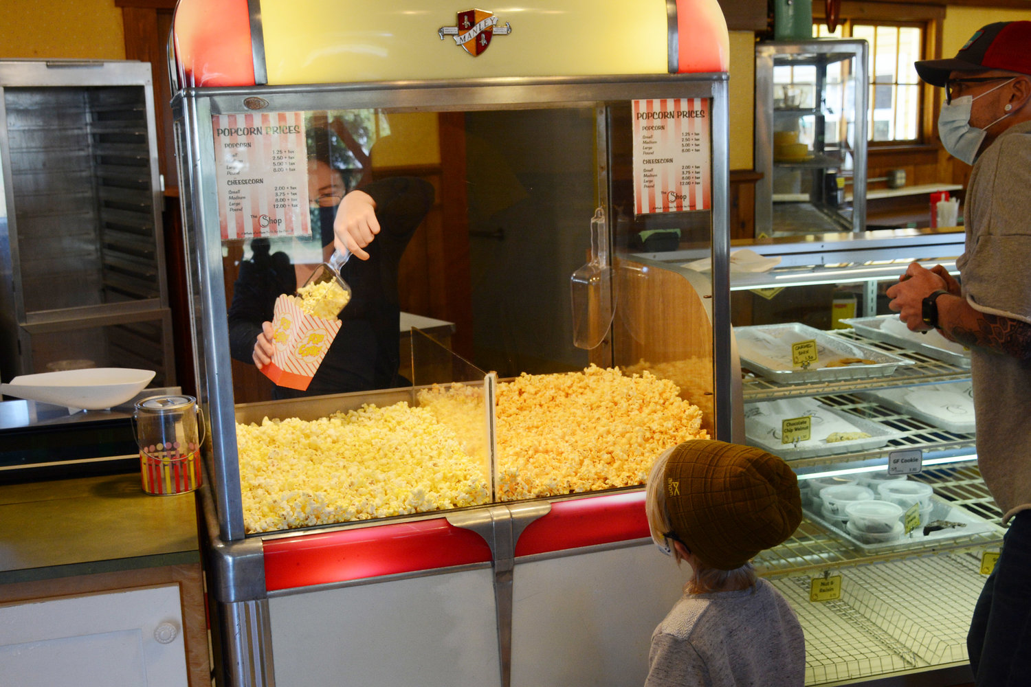 A young customer eyes buttery popcorn at The C Shop on May 7. In addition to chocolates, the shop also has popcorn, snow cones, ice cream and bakery items available.